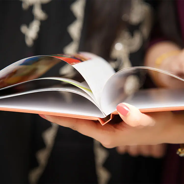 Color Kahar (colorkahar) landscape flexi leather cover photobook — hands holding flexible pages close-up display personalized Pakistan